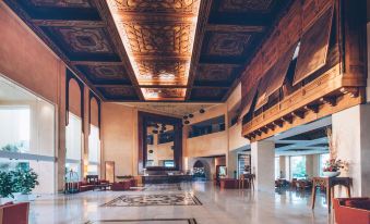 a large , ornate lobby with wooden ceiling beams and marble floors is shown in the image at Iberostar Selection Royal El Mansour