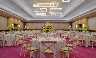 a large banquet hall with numerous tables and chairs set up for a formal event at Holiday Inn Resort Goa