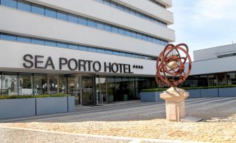 "a large hotel building with a sign that reads "" ifa porto hotel "" in front of it" at Sea Porto Hotel