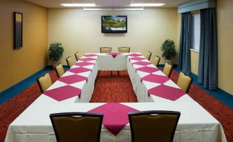 a conference room set up for a meeting with multiple tables and chairs arranged in a semicircle at Residence Inn Provo North