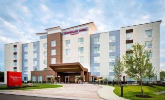 "a large , modern hotel with a red sign that says "" towneplace suites "" on it" at Homewood Suites by Hilton Dover - Rockaway