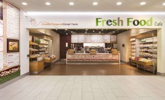 "a fresh food restaurant with a sign that reads "" fresh pastries great taste "" and a counter with various food items" at Days Inn by Wyndham Taunton