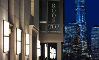 "a large building with a sign that reads "" roof top "" on it , illuminated at night" at Hyatt House Jersey City
