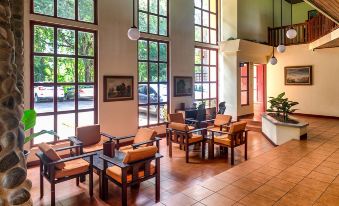 a large , open living room with multiple couches and chairs arranged in various positions , creating a comfortable space for socializing at Hotel Playa Bejuco