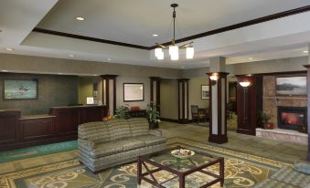a hotel lobby with a couch , chairs , and a coffee table in the center of the room at Homewood Suites by Hilton Dover - Rockaway