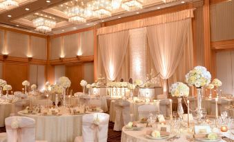 a beautifully decorated ballroom with tables covered in white tablecloths and chairs arranged for a formal event at Hotel Metropolitan Morioka New Wing