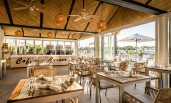 an outdoor restaurant with a large dining area , where people are seated and enjoying their meal at Lago Resort Menorca Casas del Lago
