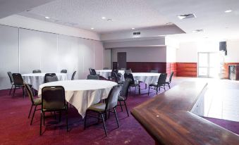 a large conference room with several round tables and chairs arranged for a meeting or event at Nightcap at Wanneroo Tavern