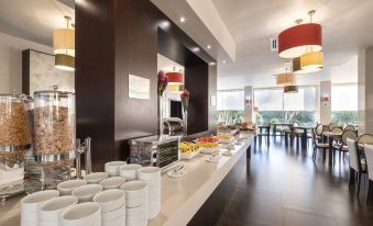 a long dining table filled with a variety of food items , including fruits and desserts at Hotel Vale Do Navio