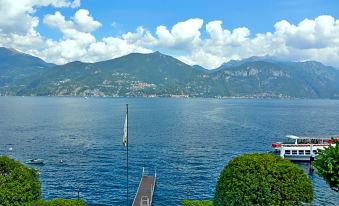 a picturesque view of a body of water , possibly a lake or ocean , with mountains in the background at Grand Hotel Menaggio