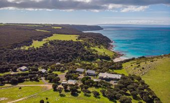 a scenic view of a coastal area with houses and green fields , overlooking the ocean at Sea Dragon Kangaroo Island