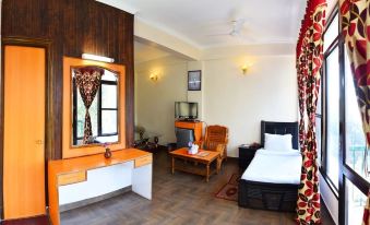 a cozy bedroom with wooden walls , a bed , and a tv , as well as a living room area at Hotel President