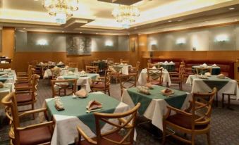 a well - decorated dining room with several tables and chairs , creating a pleasant atmosphere for guests at Keio Plaza Hotel Hachioji
