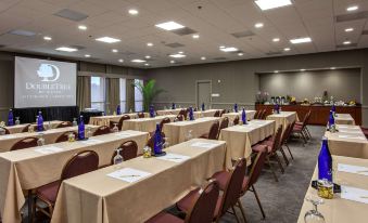 a large conference room with rows of tables and chairs , all set up for a meeting or presentation at DoubleTree by Hilton Hotel Pittsburgh - Green Tree