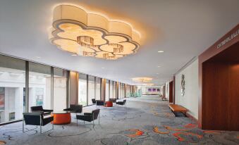 a large , well - lit room with a carpeted floor and multiple chairs arranged in rows at Hilton San Francisco Union Square