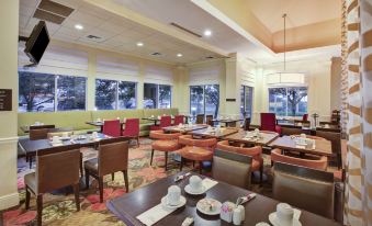 a large dining room with multiple tables and chairs arranged for a group of people to enjoy a meal together at Hilton Garden Inn Chesterton