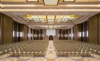 a large , empty conference room with rows of chairs and a podium at the front at Hilton Mall of Istanbul