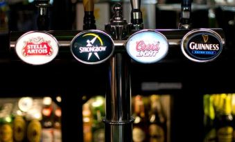 "a bar with multiple beer taps , one of which is labeled "" guinness ""." at Crofts Hotel
