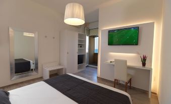 a modern bedroom with a large bed and a flat screen tv mounted on the wall at Hotel Florence