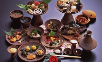 a dining table with a variety of dishes and utensils , including bowls , forks , knives , spoons , and cups at Shouen