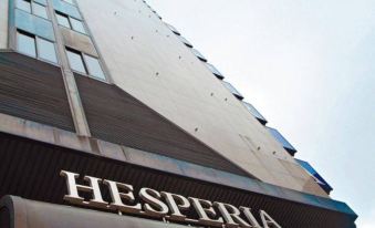 "a tall building with a sign that reads "" hesperia "" prominently displayed on the side of it" at Hesperia Vigo