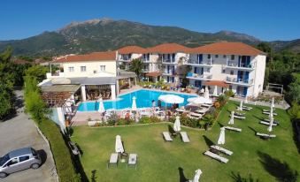 a resort with a large pool surrounded by lounge chairs and umbrellas , providing a relaxing atmosphere for guests at G George