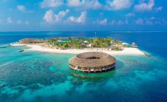 a unique circular building is located on a small island in the middle of the ocean at Kagi Maldives Resort & Spa