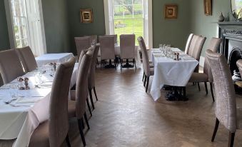 a well - decorated dining room with multiple tables and chairs , creating an inviting atmosphere for guests at Oakhill