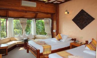 a bedroom with two beds , one on the left and one on the right side of the room at Phu Pha Nam Resort