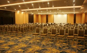 a large conference room with rows of chairs arranged in a semicircle , ready for a meeting or event at Dead Sea Spa Hotel