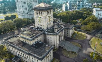 an aerial view of a large , ornate building with a clock tower and surrounding buildings at KSL Hot Spring Resort