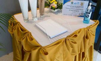 a table is set with a white object , a certificate , and vases in a vase at AVA SEA Resort Krabi