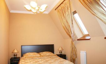 a cozy bedroom with a large bed , a dresser , and a mirror , decorated with curtains and a chandelier at Serebryanyy Bor