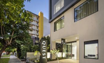 "a modern apartment building with a sign that reads "" quest "" and a courtyard in front of it" at Quest Kings Park