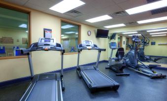 a well - equipped gym with various exercise equipment , including treadmills and stationary bikes , in a spacious room at Country Inn & Suites by Radisson, Emporia, VA