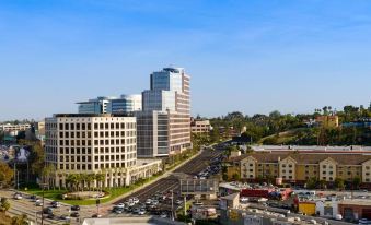 a cityscape with a large building in the center , surrounded by various other buildings and traffic at Hilton Los Angeles-Culver City, CA