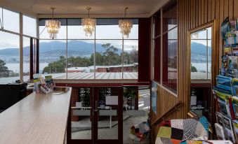 a room with a large window overlooking a body of water , creating a serene and peaceful atmosphere at City View Motel