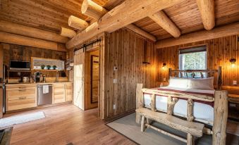 a room with a wooden ceiling and walls , featuring a bed in the center of the room at Boulder Mountain Resort