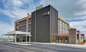 "a large hotel building with a green awning and the words "" home 2 "" on its side" at Home2 Suites by Hilton Helena