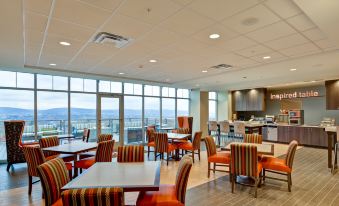 a large dining room with tables and chairs arranged for a group of people to enjoy a meal at Home2 Suites by Hilton Dickson City Scranton