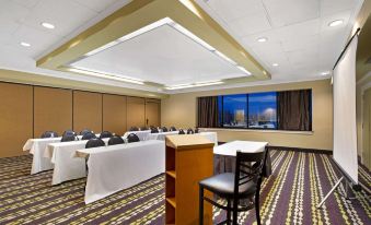 a conference room with chairs arranged in rows and a podium at the front of the room at La Quinta Inn & Suites by Wyndham Springfield MA