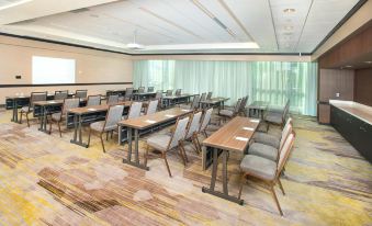 a large conference room with multiple rows of chairs arranged in a semicircle around a long table at Courtyard Redwood City