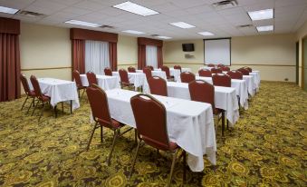 a conference room set up for a meeting , with tables and chairs arranged in rows at Country Inn & Suites by Radisson, Watertown, SD