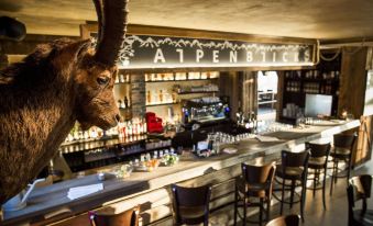 a bar with a long wooden counter and a goat statue on top of the counter at Alpenblick Weggis - Panorama & Alpen Chic Hotel