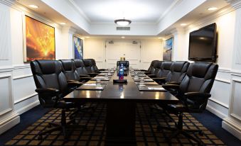 a large conference room with a long table , chairs , and a painting on the wall at Inn at Pelican Bay