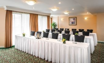 a conference room set up for a meeting , with rows of chairs arranged in a semicircle at Hotel Grand Pacific