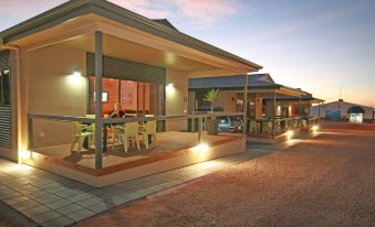 a group of people gathered outside a building , enjoying each other 's company and engaging in conversation at Streaky Bay Hotel Motel