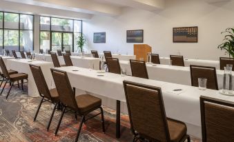 a conference room with several chairs arranged in rows and a podium at the front at Sheraton Kauai Coconut Beach Resort