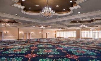 a large , empty ballroom with a carpeted floor and multiple chandeliers hanging from the ceiling at St. Kitts Marriott Resort & the Royal Beach Casino
