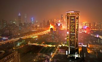 cityscape with buildings illuminated at night at Jin Jiang Tower